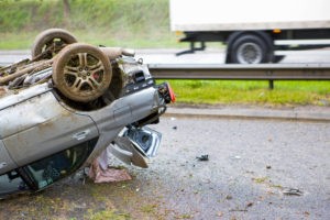 car lying upside-down in the road